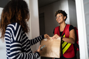 Person grabbing food & online ordering via Shutterstock