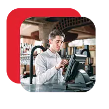 Restaurant staff member entering an order on a POS terminal at the bar.