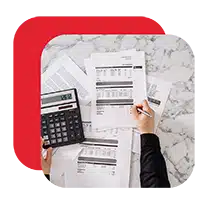 Person calculating expenses using printed bills and receipts.